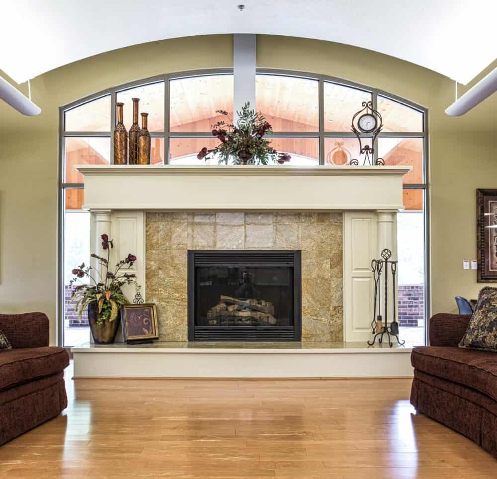 Interior room with a fireplace and ample seating in a senior living community in Green Bay, Wisconsin.