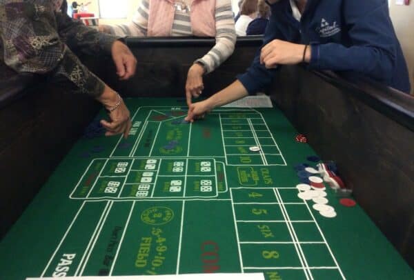 Group of seniors playing a game of Craps at senior living community in Green Bay, Wisconsin.