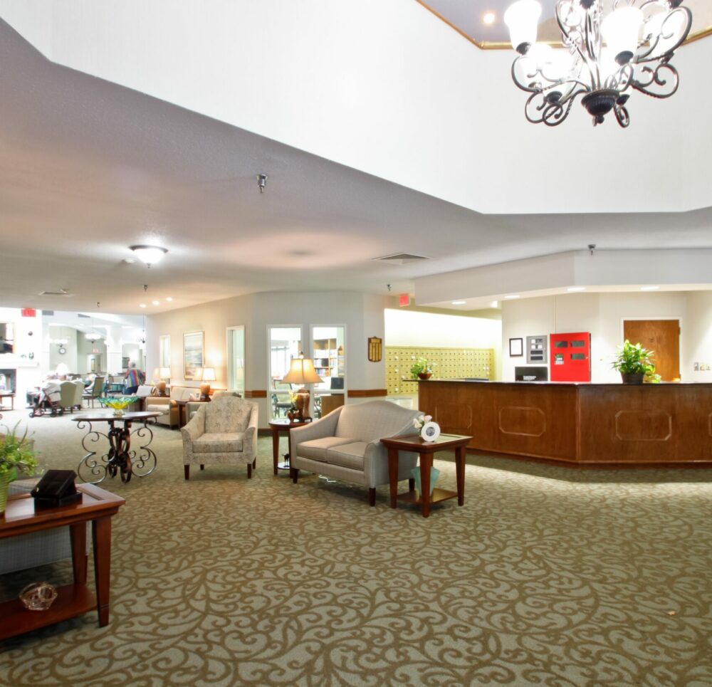 Lobby area with seating and large front desk at a senior living community in Raleigh, North Carolina.