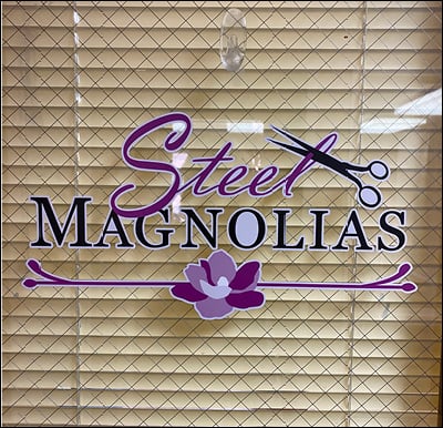 “Steel Magnolias” sign on a door to an on-site salon.
