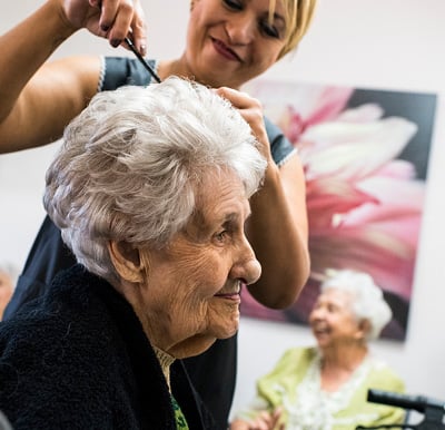 Senior woman getting her haircut at a salon.