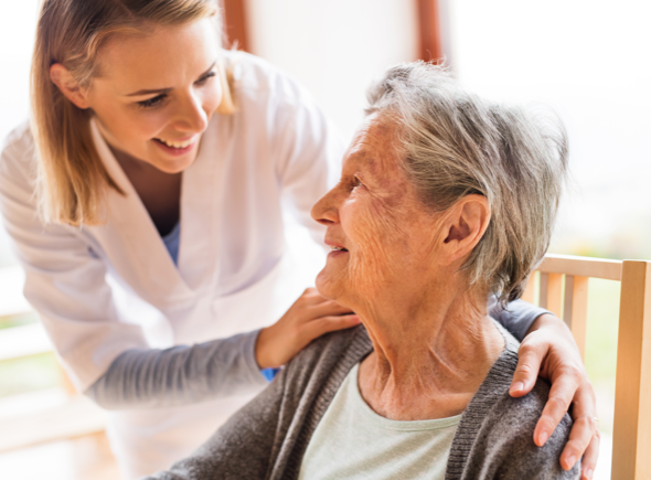 Nurse smiling with a senior woman