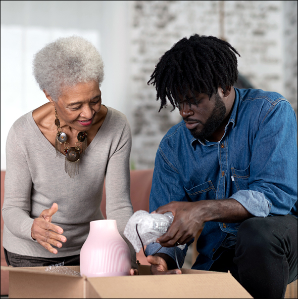 Grandson helping his grandmother unpack in her new home
