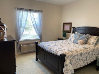 Senior apartment bedroom with full size bed in Richardson, Texas.