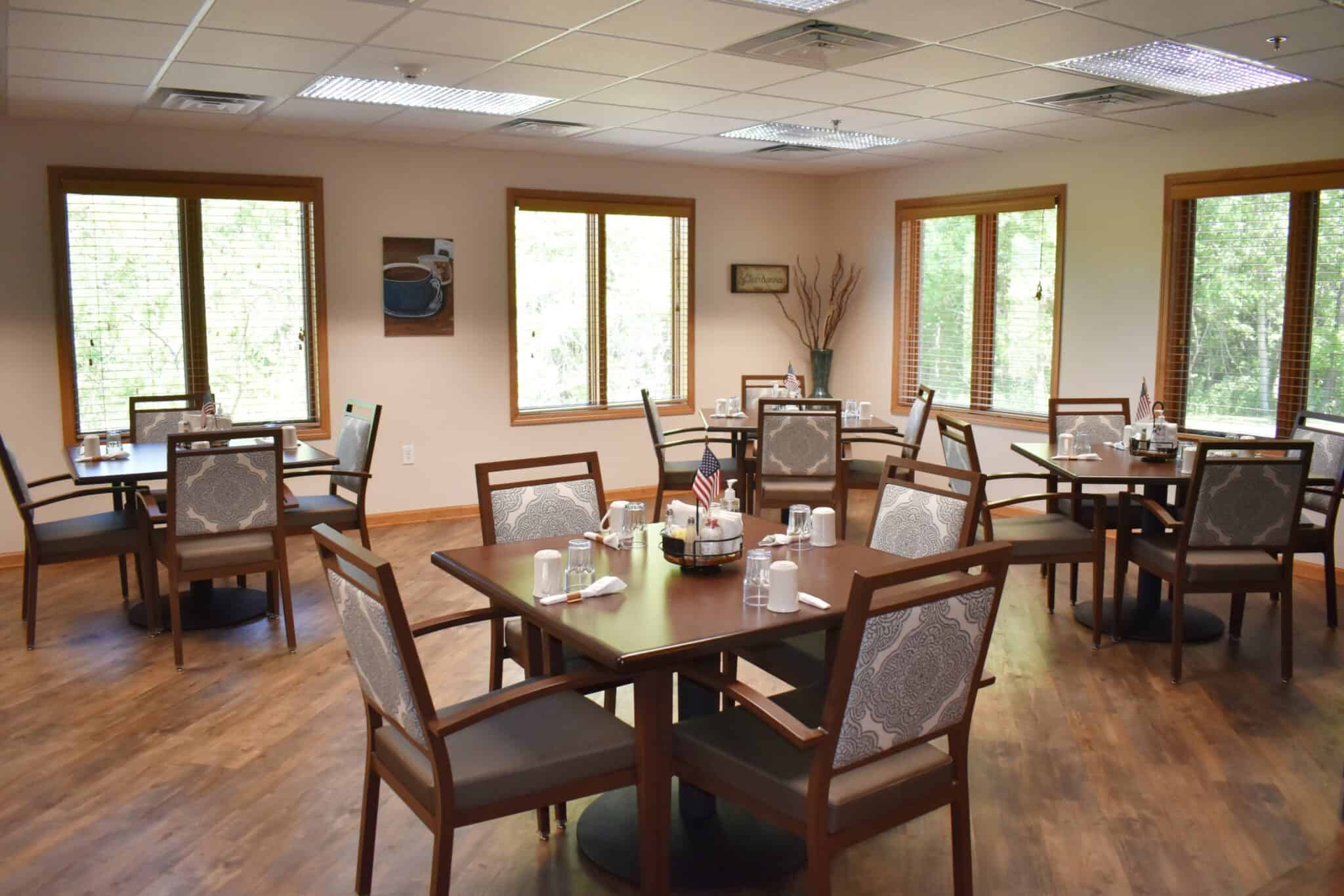 Dining room with ample seating at a senior living community in Green Bay, Wisconsin