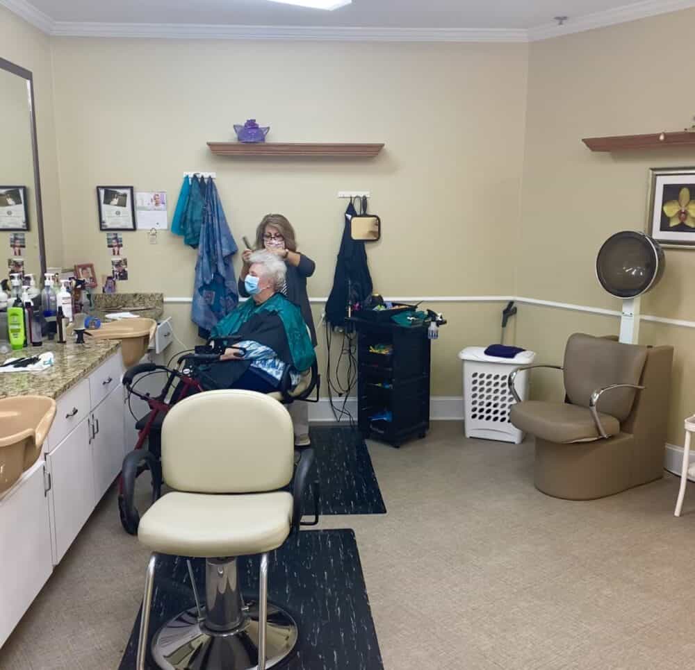 Senior woman gets her hair done a senior living community in Mesquite, Texas.