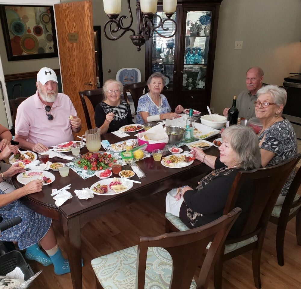 Group of seniors eat a meal together during cooking club at a senior living community in Raleigh, North Carolina.