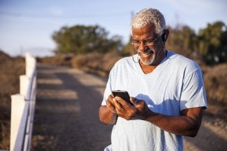 Senior man has an enjoyable conversation on his phone.