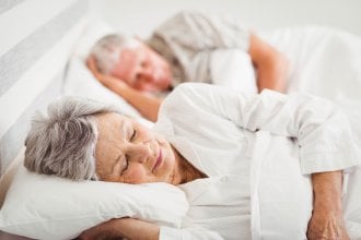 Senior couple sleeping in a bed.