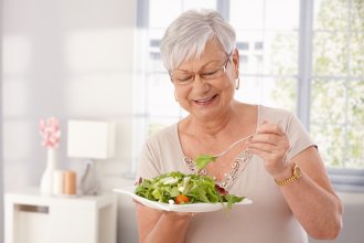 Senior woman eating salad