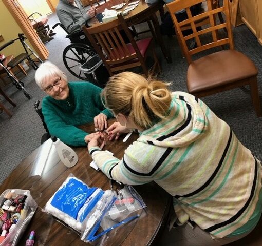 Senior woman gets her nails done at a senior living community in Colby, Wisconsin.