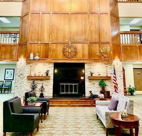 large, tall fireplace near a seating area at crown pointe senior living
