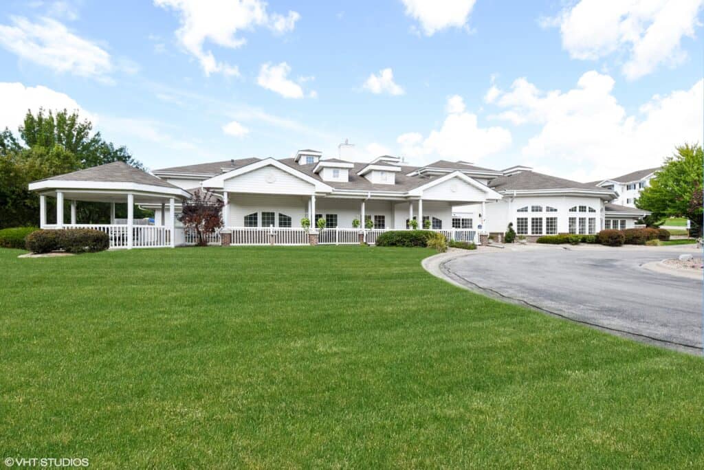 Exterior view with circular driveway of senior living facility in Omaha, Nebraska.