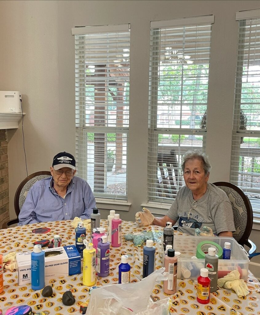 Senior man and woman do some painting together at a senior living community in Conroe, Texas.