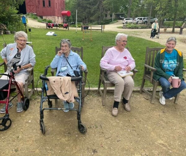Four senior women sitting outside at a senior living community in West Bend, Wisconsin.