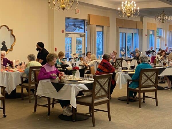 Large group of seniors eating at dinner at a senior living community located in Ridgeland, Mississippi.