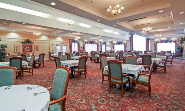 Dining room with ample seating and natural light at a senior living community in Fairfield, Ohio.