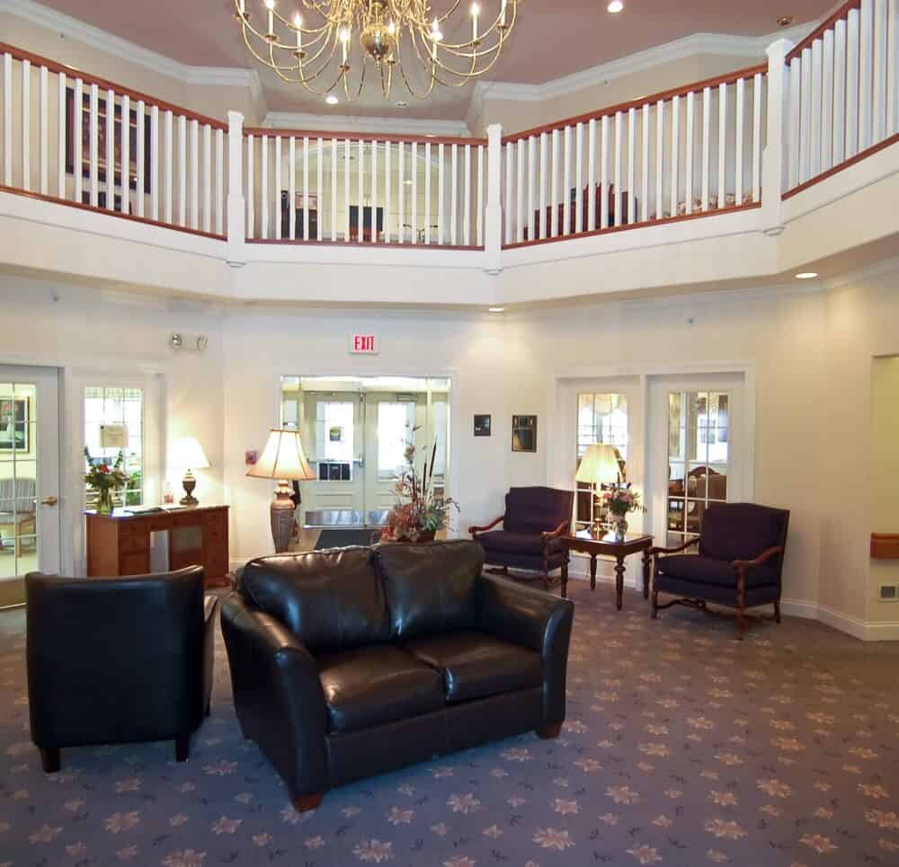 Large, two-story lobby and staircase at a senior living community in Rochester, Indiana.