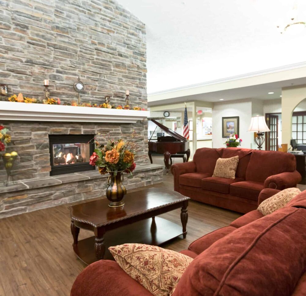 Lounge area at a senior living community in Elkhorn, Nebraska with impressive fireplace and comfortable seating area.