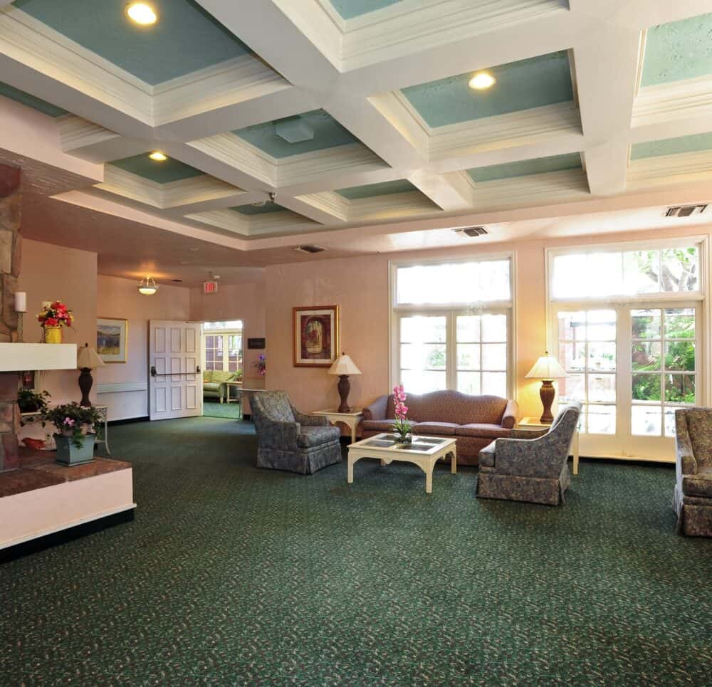 Lobby area with a fireplace at the Villa Santa Barbara, a senior living community in Santa Barbara, California.