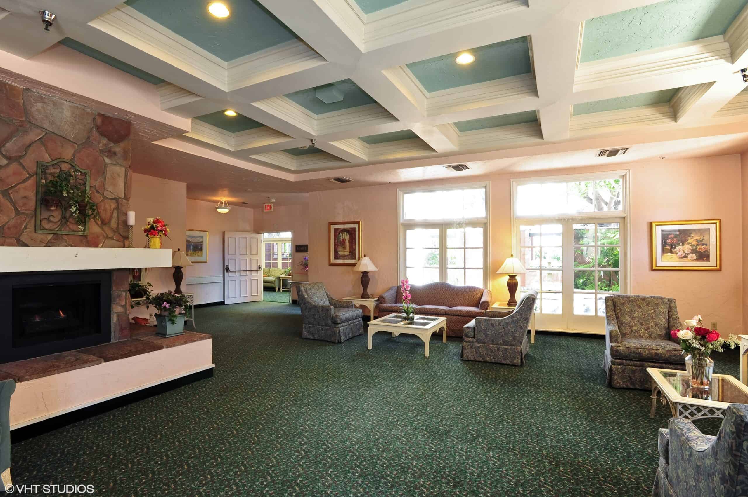 Lobby area with a fireplace at the Villa Santa Barbara, a senior living community in Santa Barbara, California.