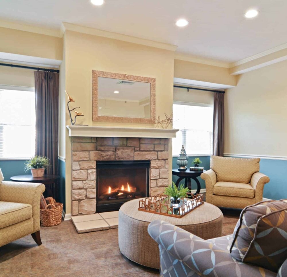 Lounge area at a senior living community with fireplace and comfortable seating in Chardon, Ohio.