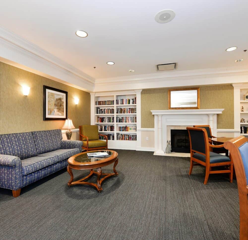 Lounge with couches and books at a senior living community in Virginia Beach, Virginia.