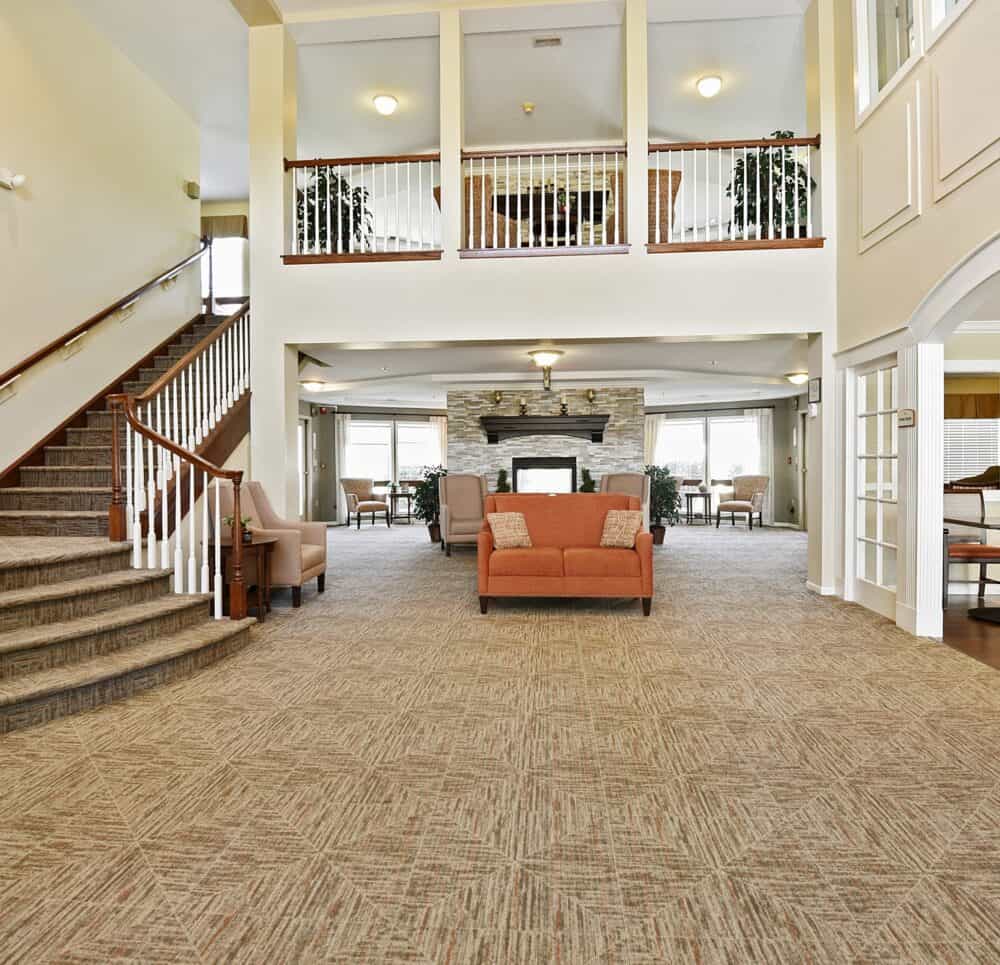 Lobby area with staircase at a senior living facility in Omaha, Nebraska.