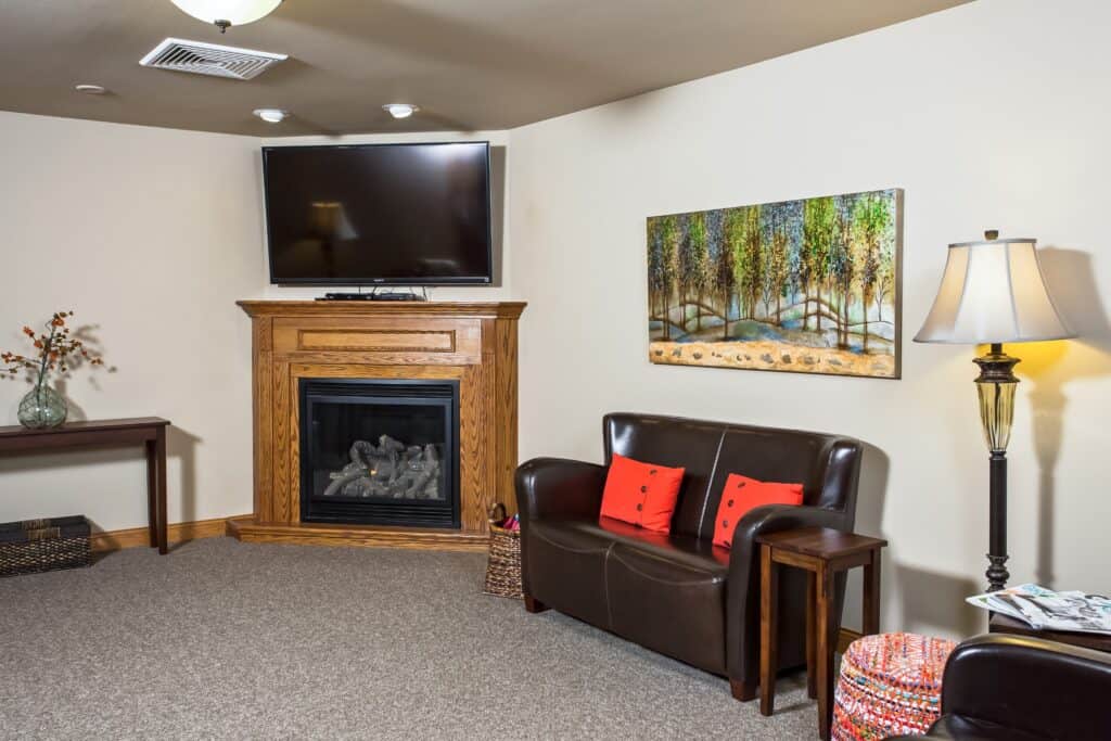 Lounge area with TV at a senior living community located in West Bend, Wisconsin.