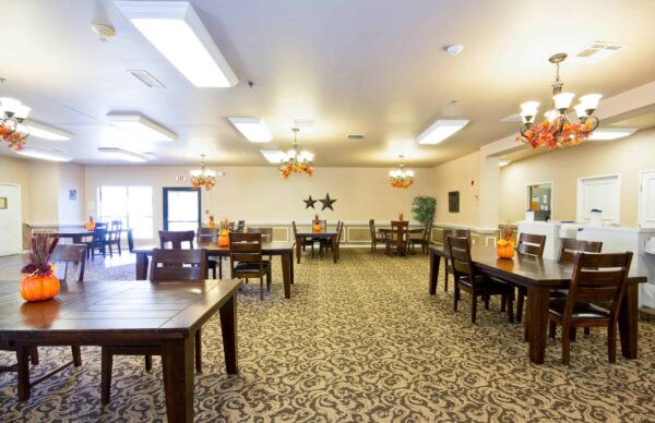 Dining room with family-style seating at a senior living community in College Station, Texas.
