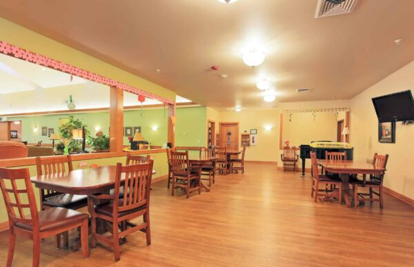 Dining room with ample seating and lighting at senior living facility in Colby, Wisconsin.
