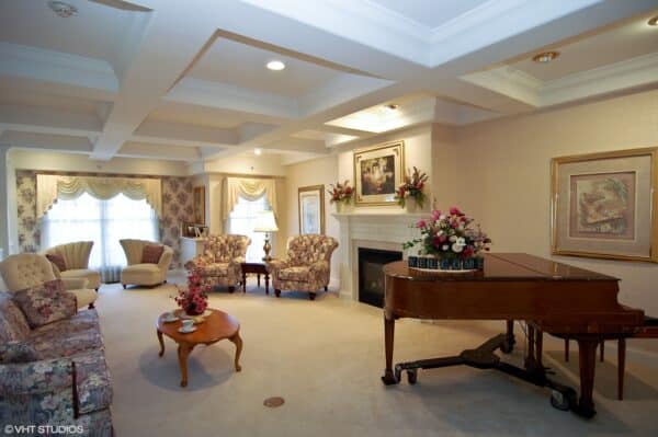 Lounge area with piano at a senior living community in Rochester, Indiana.