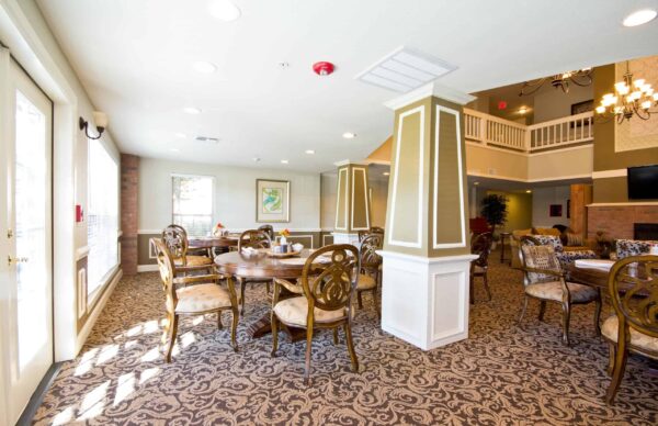 Dining area at a senior living community in Conroe, Texas with chandeliers and comfortable seating.