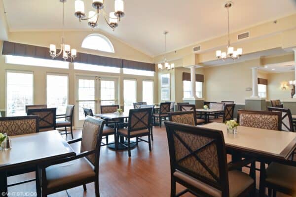 Dining room at a senior living community with lots of natural light and ample seating in Chardon, Ohio.