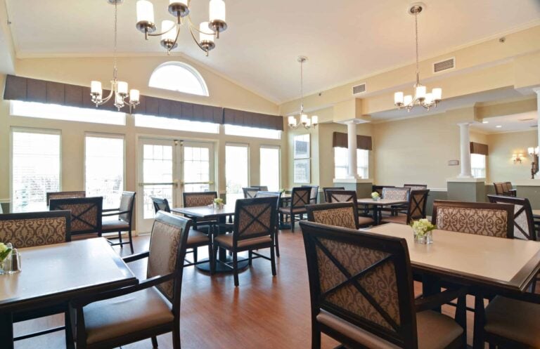 Dining room at a senior living community with lots of natural light and ample seating in Chardon, Ohio.