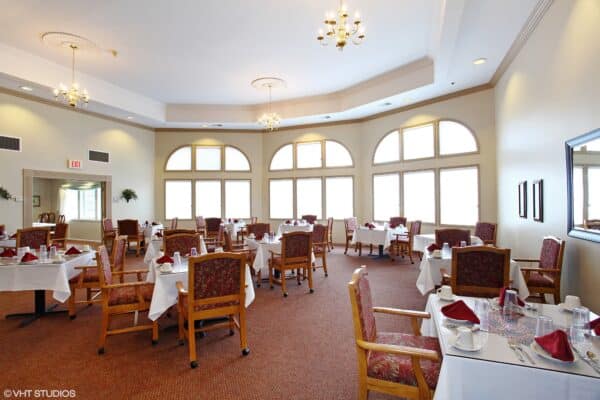 Dining room with comfortable seating and natural lighting at a senior living facility in Lincoln, Nebraska.