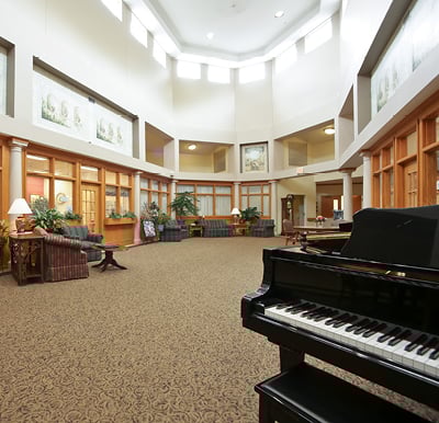 Interior room with a piano, large ceilings and ample seating in Lambertville, Michigan.