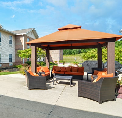 Large gazebo shading outdoor lounge furniture in a courtyard in Mansfield, Ohio.