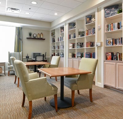 Bright and beautiful library with a wall lined with bookshelves and table seating in Mansfield, Ohio.
