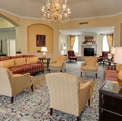 Elegant rotunda with comfortable sofas and armchairs under a beautiful chandelier in Plano, Texas.