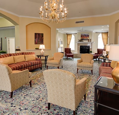Elegant rotunda with comfortable sofas and armchairs under a beautiful chandelier in Plano, Texas.