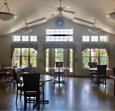 Activity room with many tables and large windows in Plymouth, Wisconsin.