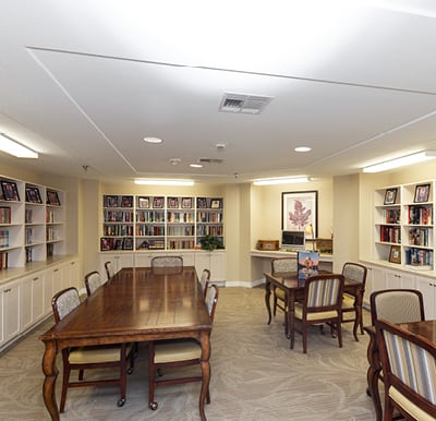 A library filled with bookshelves and books at a senior living community in Baytown, Texas.