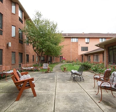 Large courtyard with outdoor seating and landscaping in East Lansing, Michigan.
