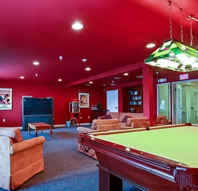 Our well-appointed billiards room with comfortable chairs and big-screen TV in Fitchburg, Wisconsin.