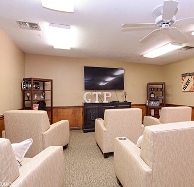 A theatre room with a big-screen TV and lots of comfortable lounge chairs in Fort Wayne, Indiana.