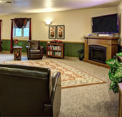 Cozy fireplace with comfortable couches and armchairs in Hartford, Wisconsin.