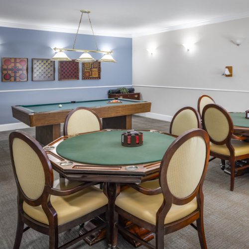 Game room with a billiards table and two game tables