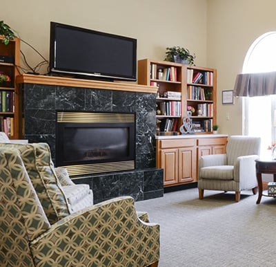A fireplace with a big-screen TV and bookshelves surrounding in Anderson, Indiana.