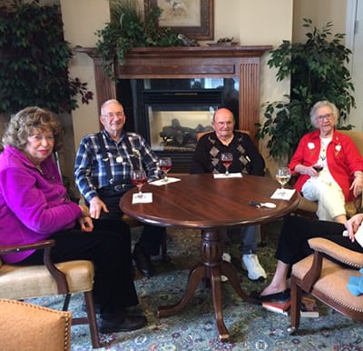 A group of elderly men and women gathered around a table during Happy Hour in Perrysburg, Ohio.